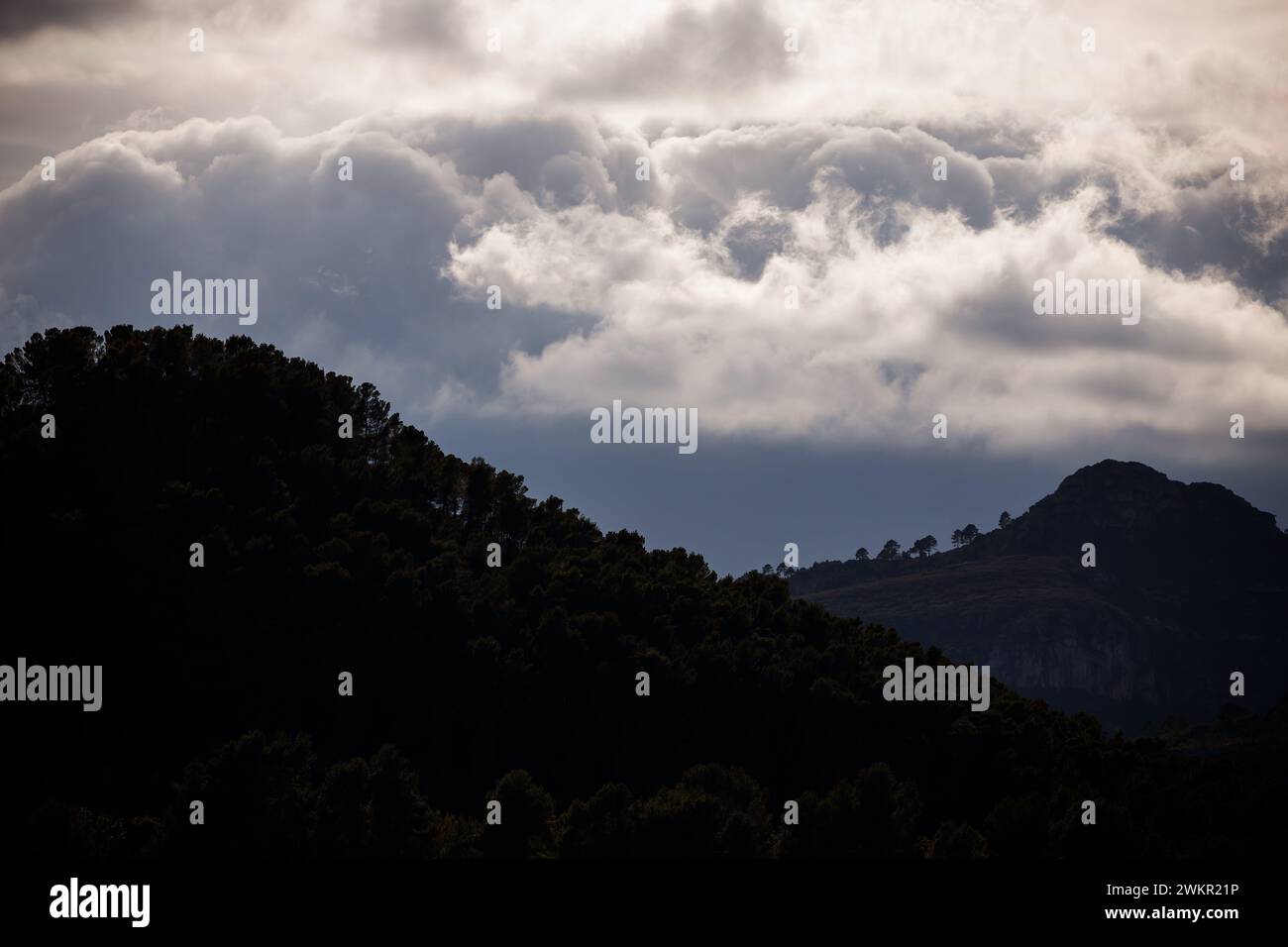 The hills of Xeraco under iridescent clouds Stock Photo