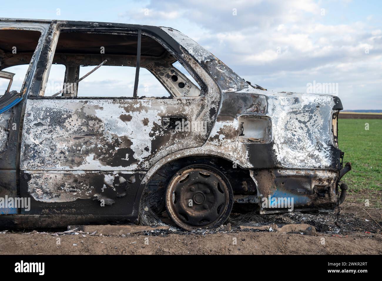 A burned out car. Burnt car in the field. Car fire, vehicle fire due to ...