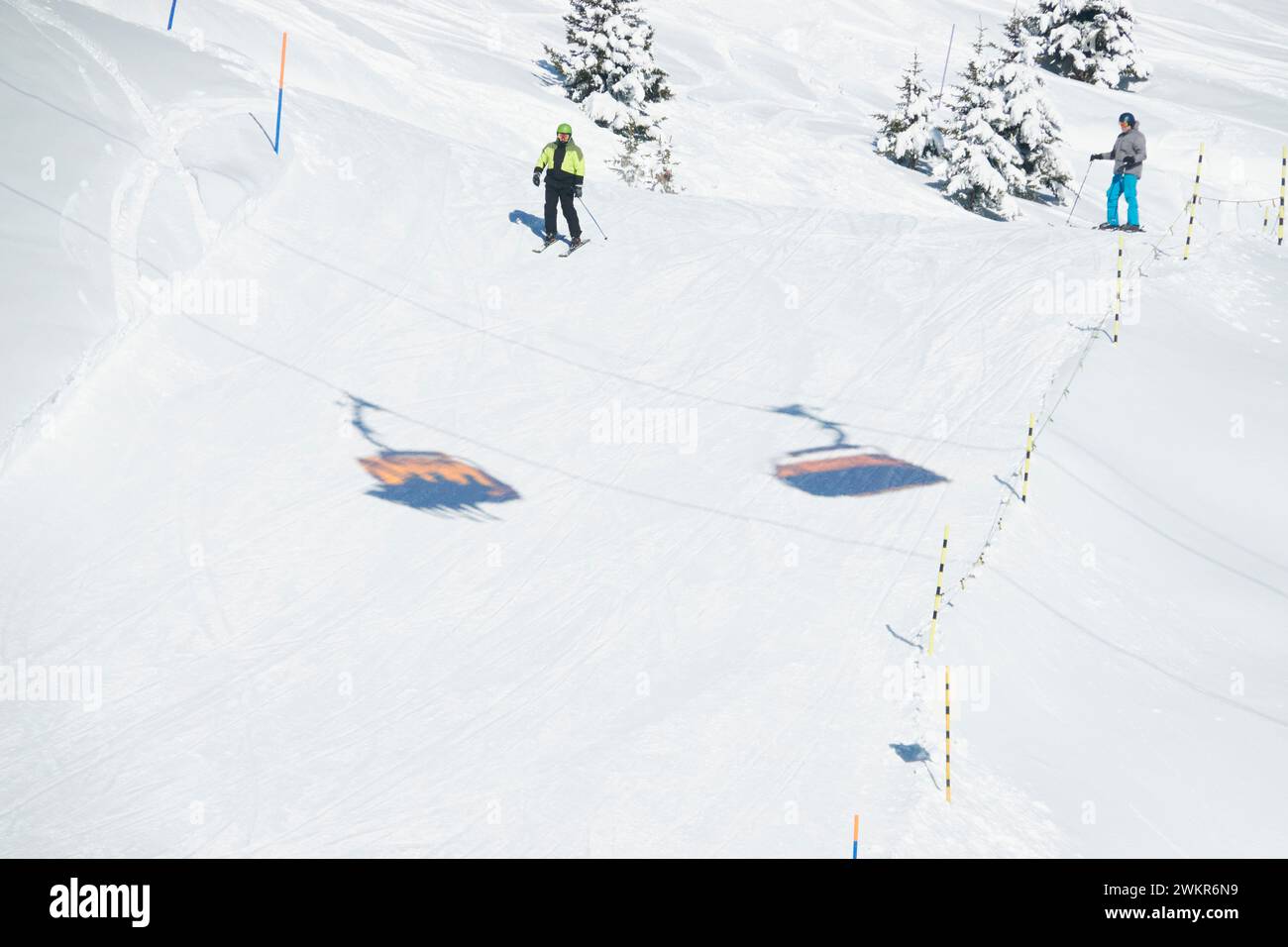 The skiers in action on a snowy hillside in Bettmeralp, Wallis, Switzerland. Stock Photo