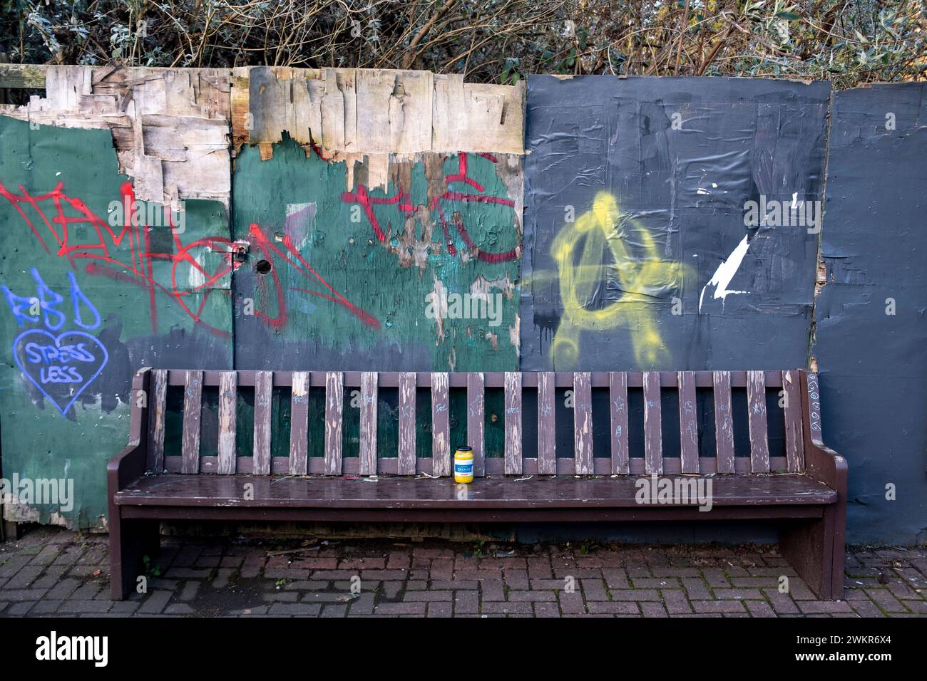 Jar of piccalilli on a street bench next to a falling down fence on 22nd January 2024 in Birmingham, United Kingdom. Stock Photo