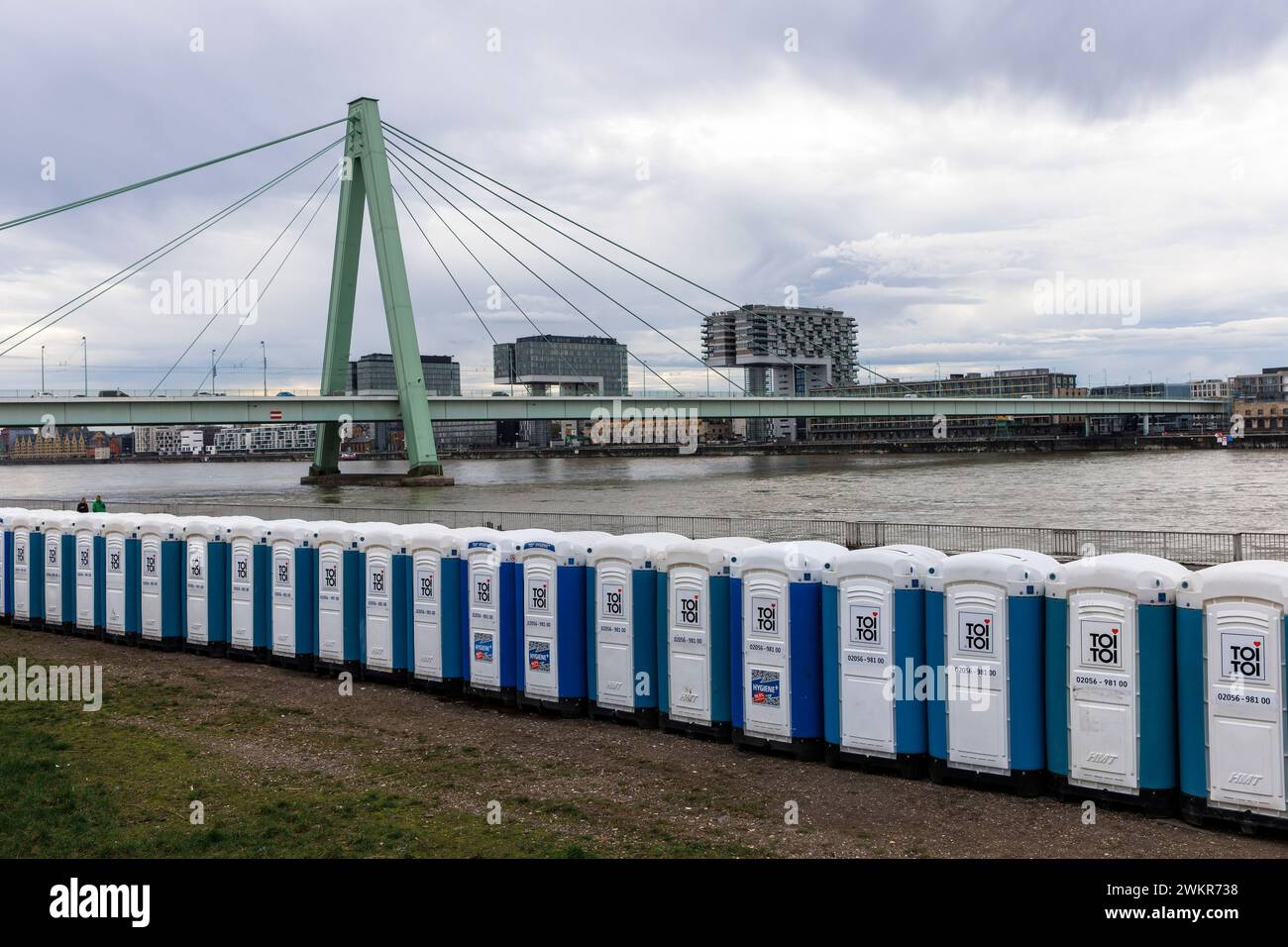 a large number of porta-potties are located after the carnival days at Deutzer Werft, banks of the Rhine in the district Deutz, view to Severins bridg Stock Photo