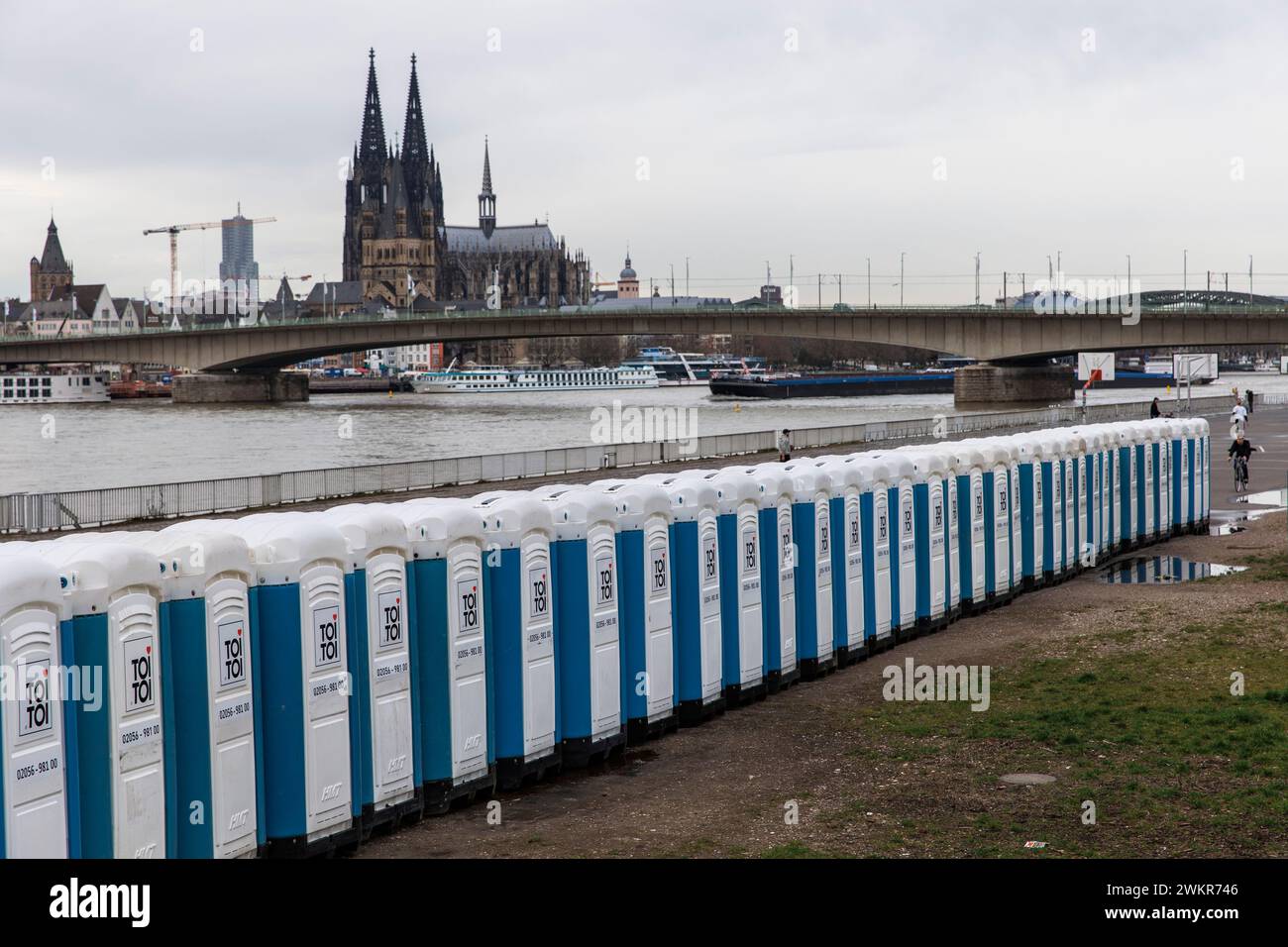 a large number of porta-potties are located after the carnival days at Deutzer Werft, banks of the Rhine in the district Deutz, view to the cathedral, Stock Photo