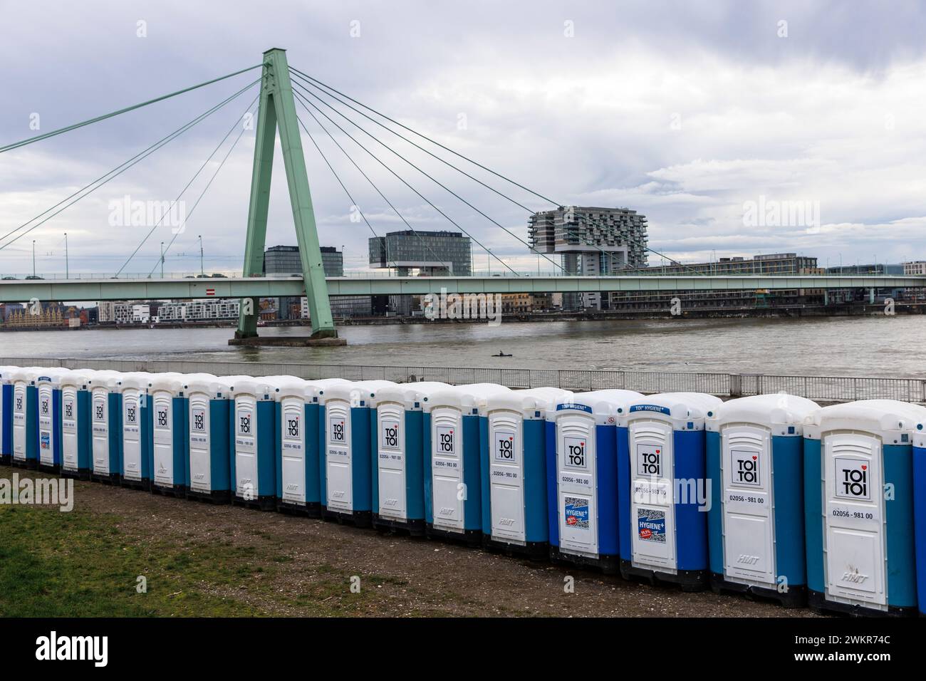 a large number of porta-potties are located after the carnival days at Deutzer Werft, banks of the Rhine in the district Deutz, view to Severins bridg Stock Photo