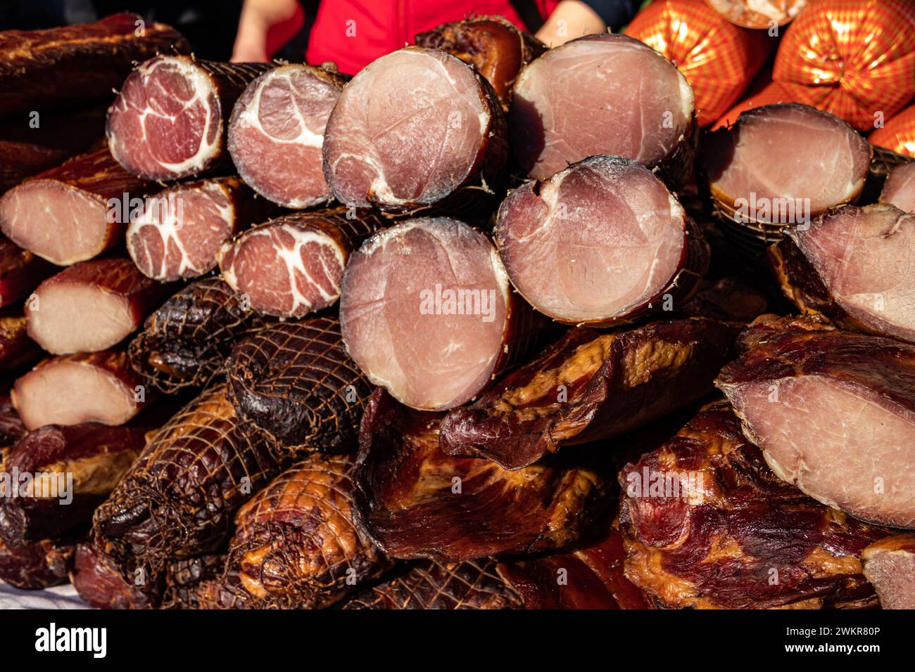 Delicious pieces of smoked meat exposed for sale in the market  presented for sale on a farmer's market in Kacarevo village, gastro bacon and dry meat Stock Photo