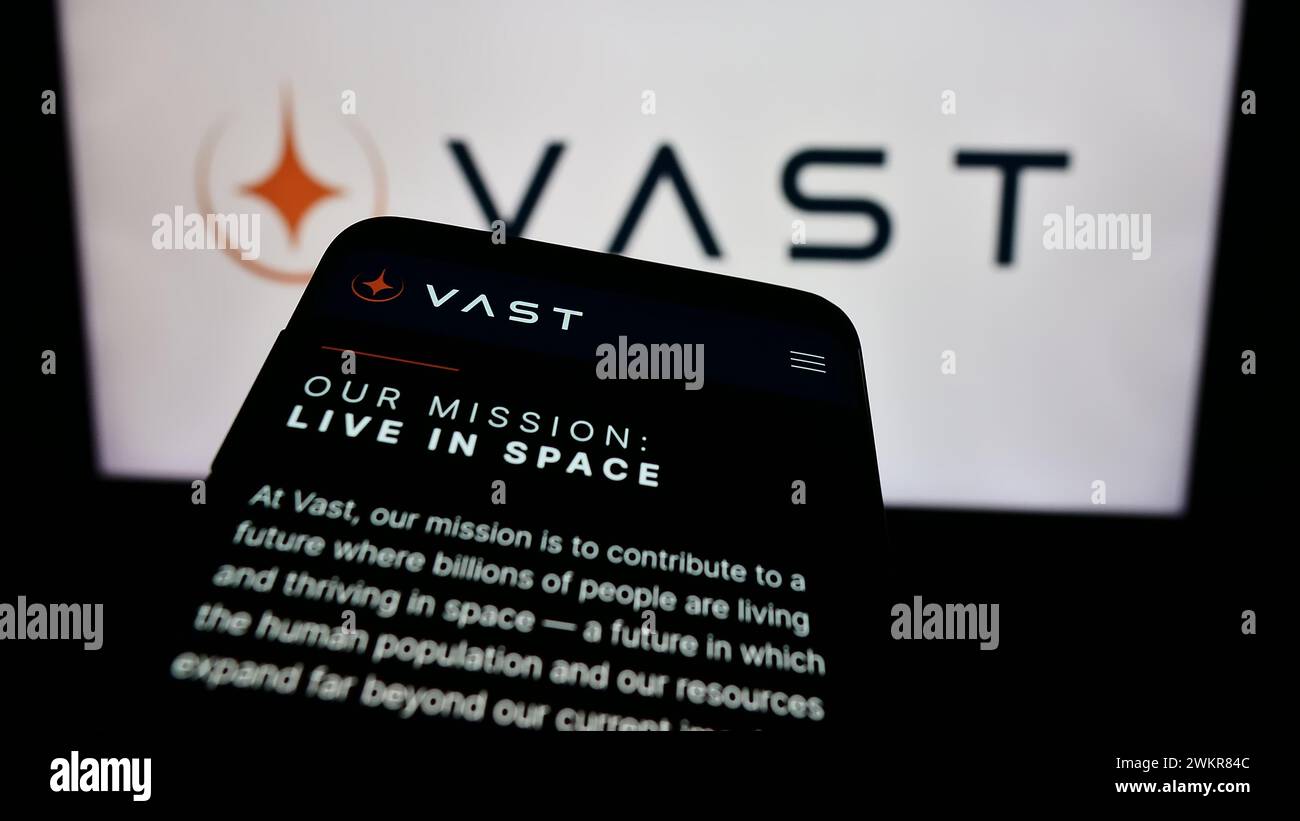 Smartphone with website of US aerospace company VAST Space LLC in front of business logo. Focus on top-left of phone display. Stock Photo
