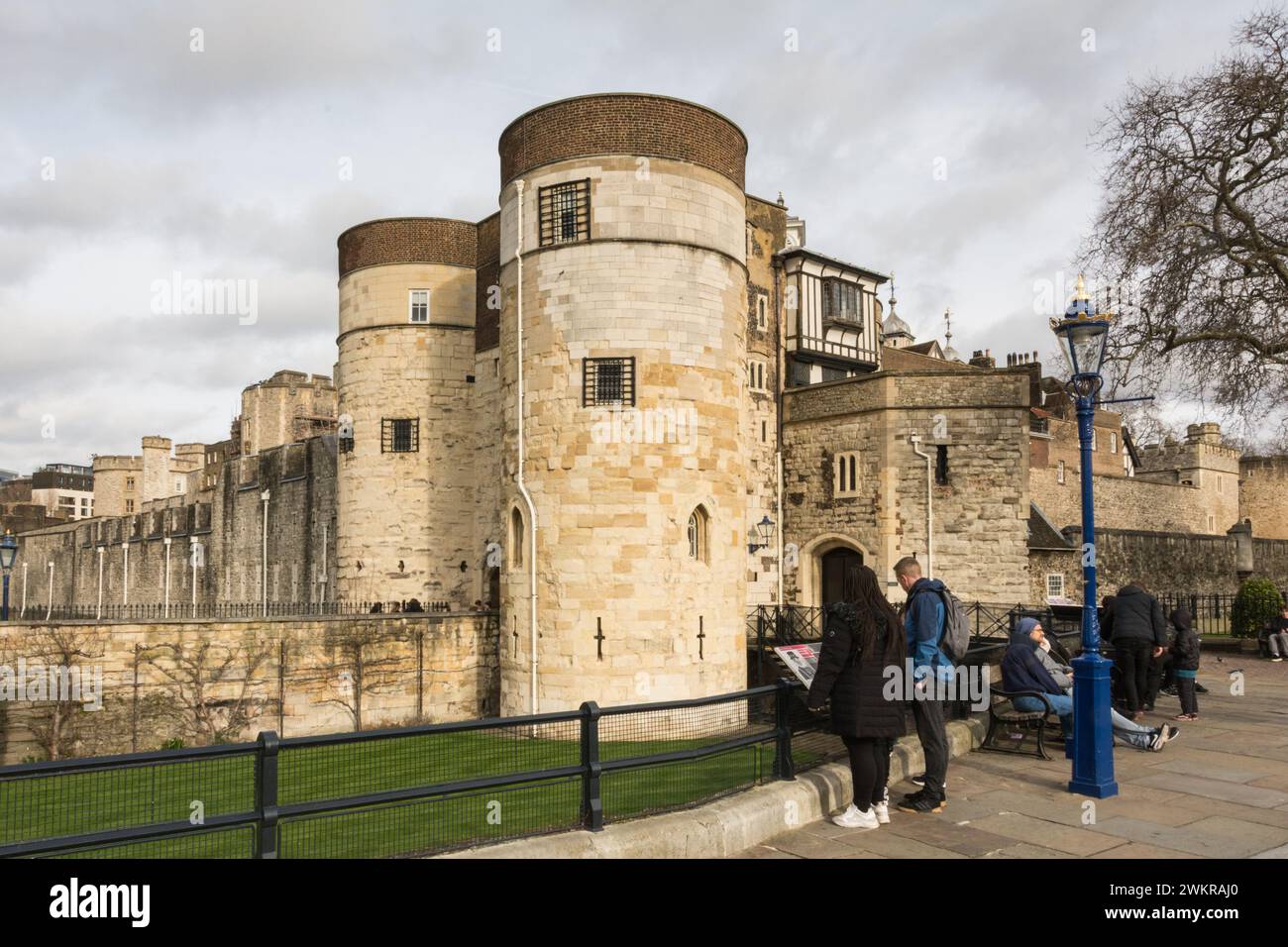Tourists exploring Byward Tower and the moat in front of the Tower of London, City of London, England, U.K. Stock Photo