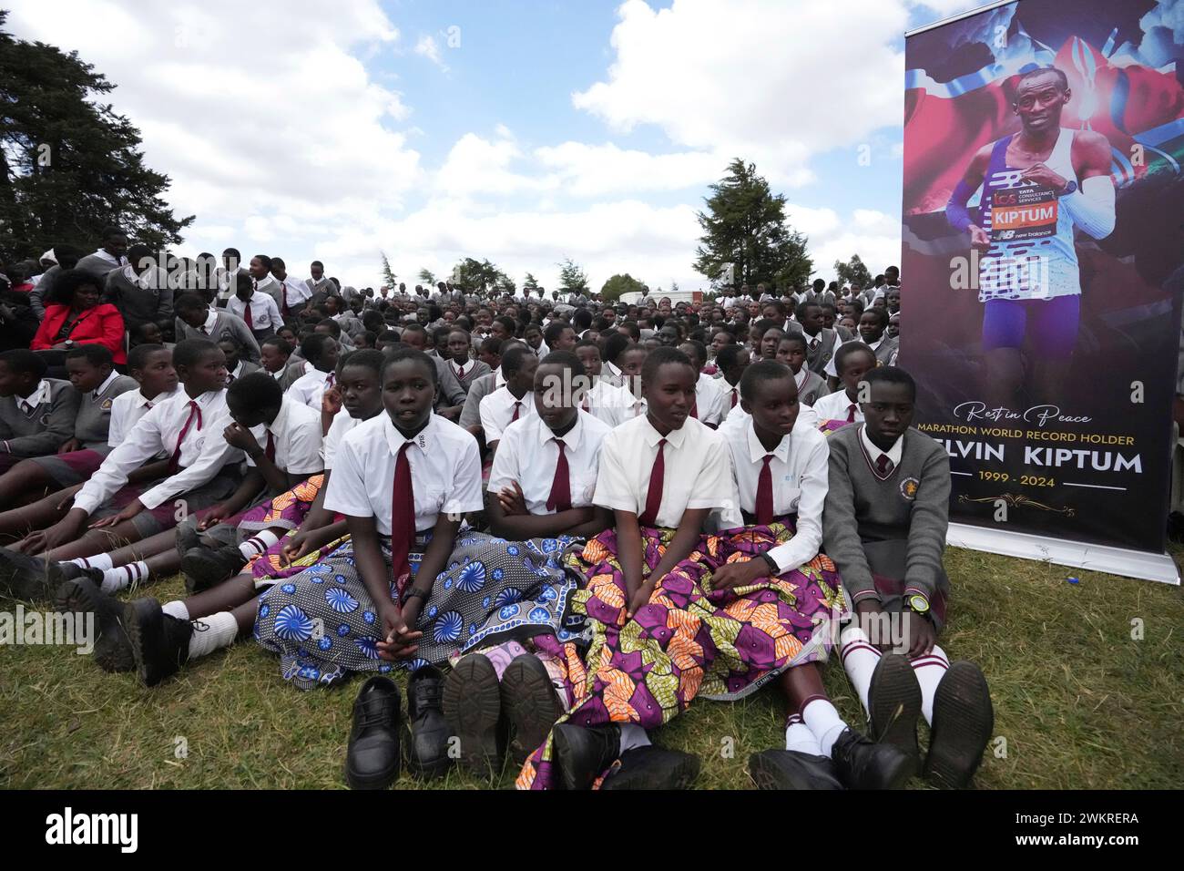 School children gather around the casket of Kenyan athlete Kelvin ...