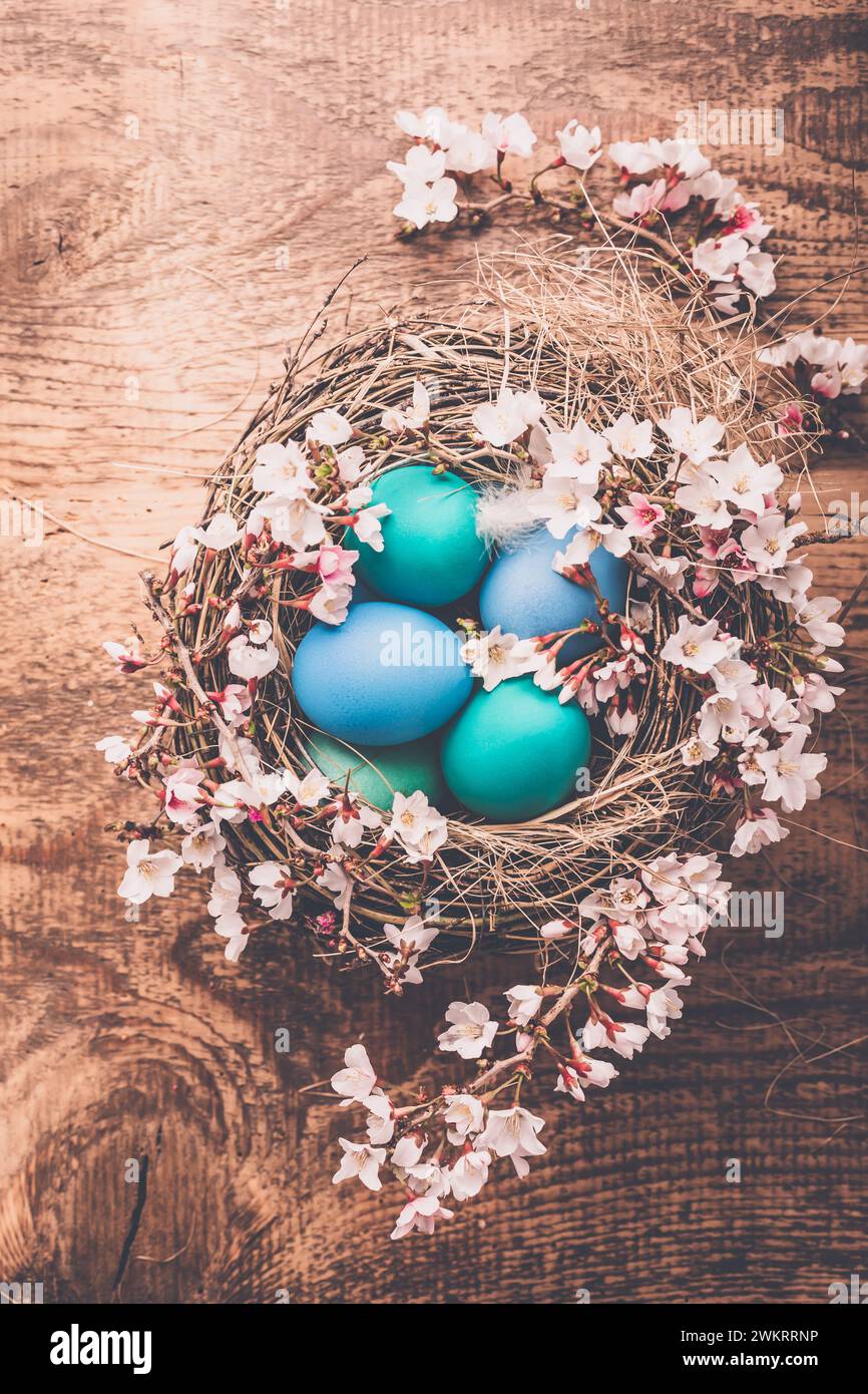 Easter background with colorful eggs in nest on wooden background Stock ...