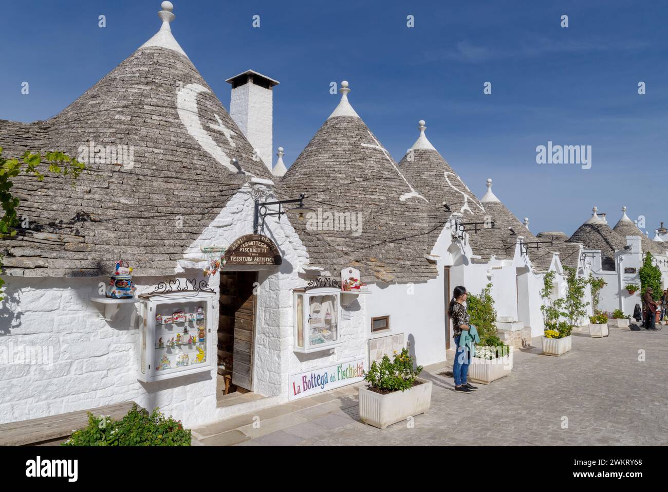 Trulli buildings and shops, Via Monte San Michele, Alberobello, Bari province, Puglia region, Italy Stock Photo