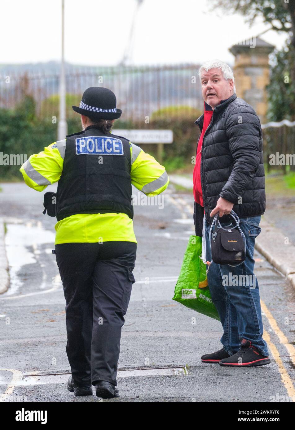 A police officer speaks to a member of the public after homes were ...