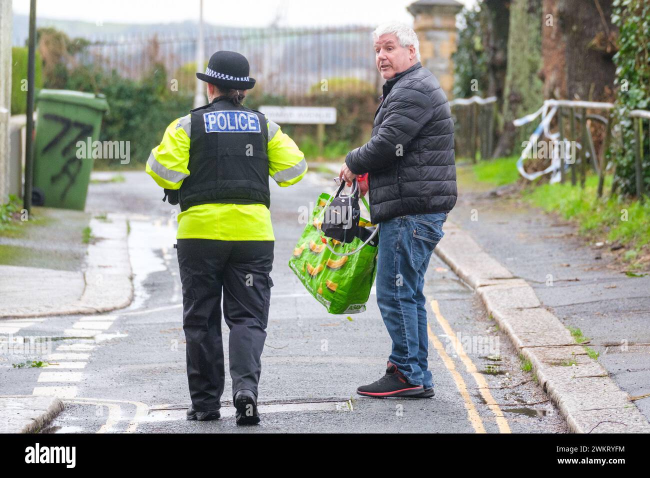 A police officer speaks to a member of the public after homes were ...
