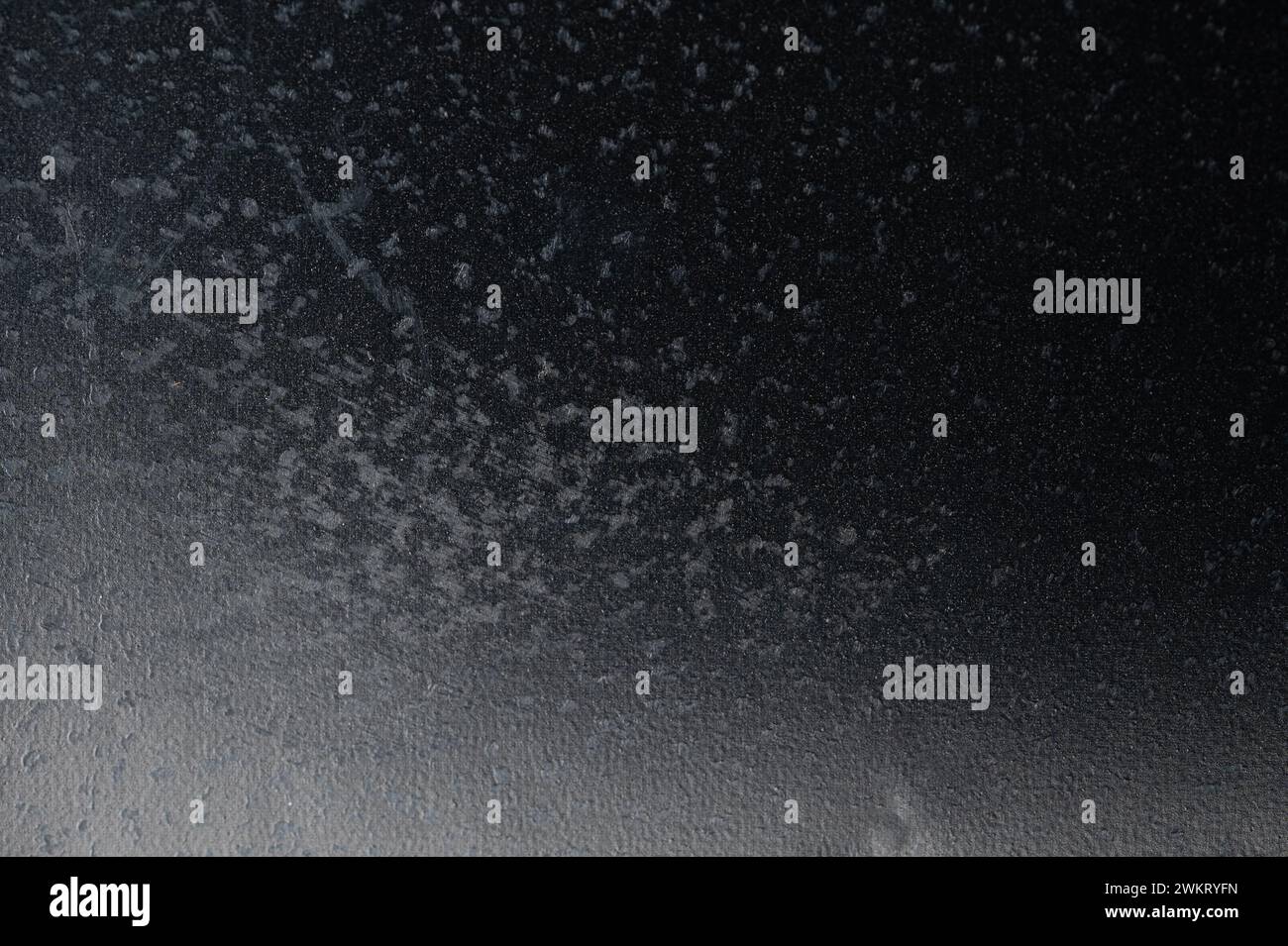 Black plastic background with gray spots macro close up view Stock Photo