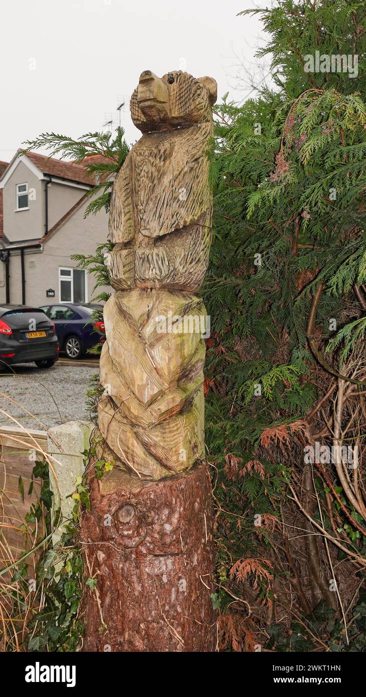 Man-made totem poles of a bear, at a front garden in Eastwood Road, Rayleigh Stock Photo