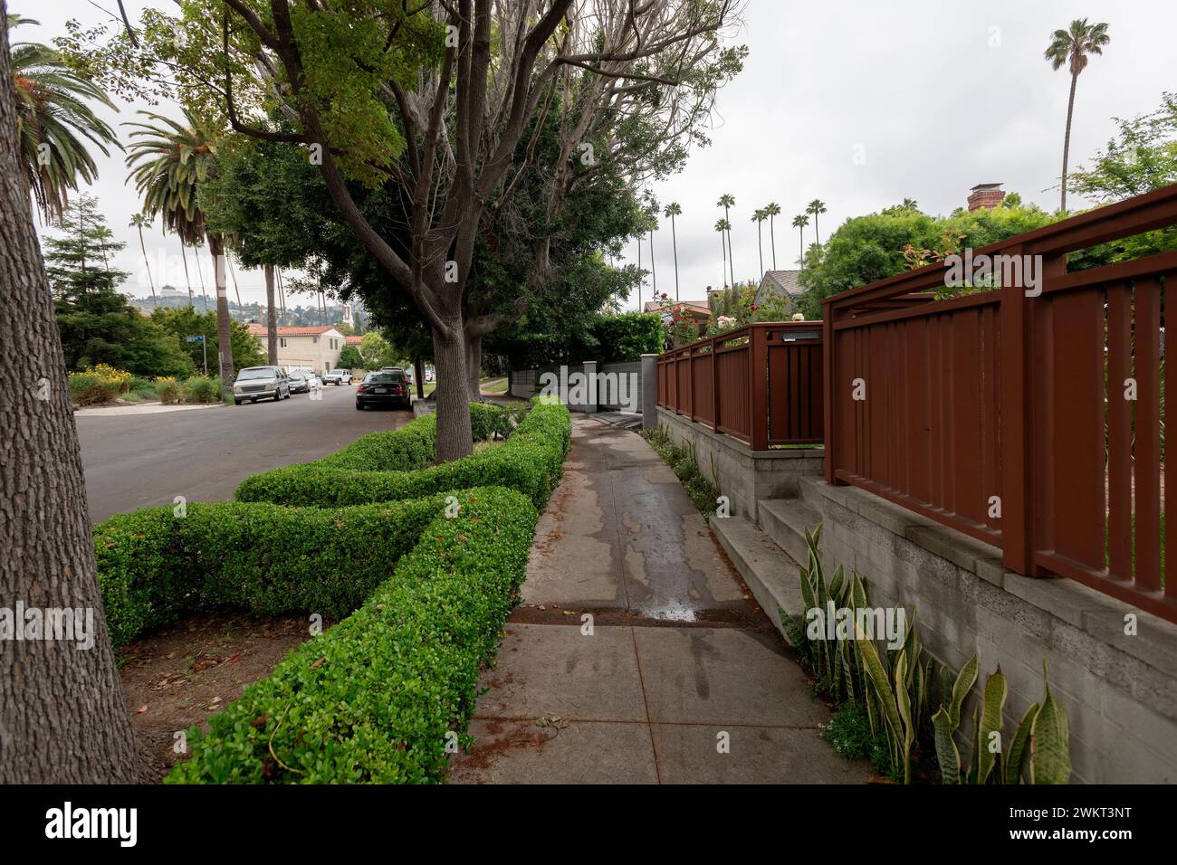 USA, Los Angeles, California. Water streaming from home to sidewalk. Stock Photo