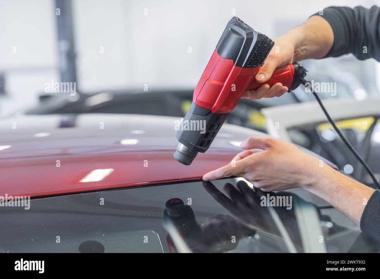 Wrapping a new foil to a car by heat gun, gluing a new foil, detailing