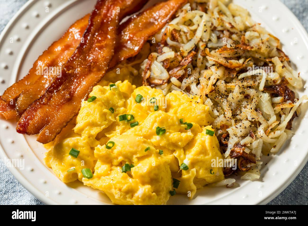Healthy Homemade American Bacon Egg and Hashbrown Breakfast with Salt and Pepper Stock Photo