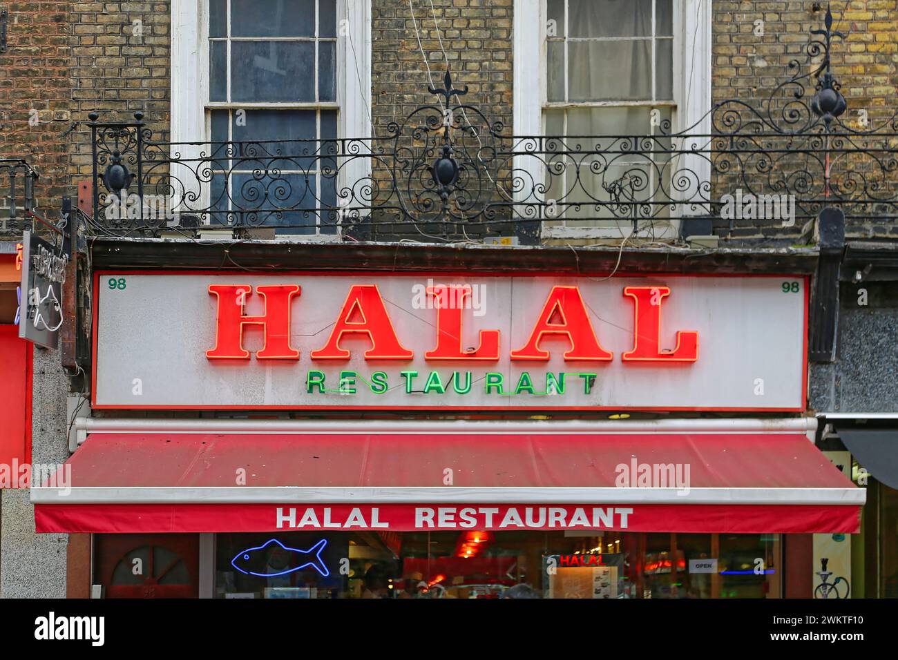 London, United Kingdom - November 24, 2013: Big Red Neon Sign Halal at Middle East Cuisine Restaurant in City Centre. Stock Photo