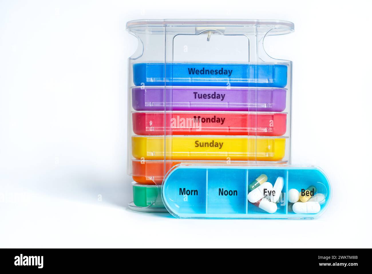 A stackable weekly four times a day pill organiser. The tablet box has a tray for each day of the week with four marked separate compartments. Stock Photo