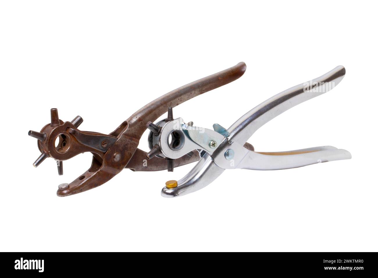 Tailor accessories. Close-up of a antique adjustable steel punch pliers and a modern hole punch tool isolated. Clipping path. Tools from tailor, saddl Stock Photo