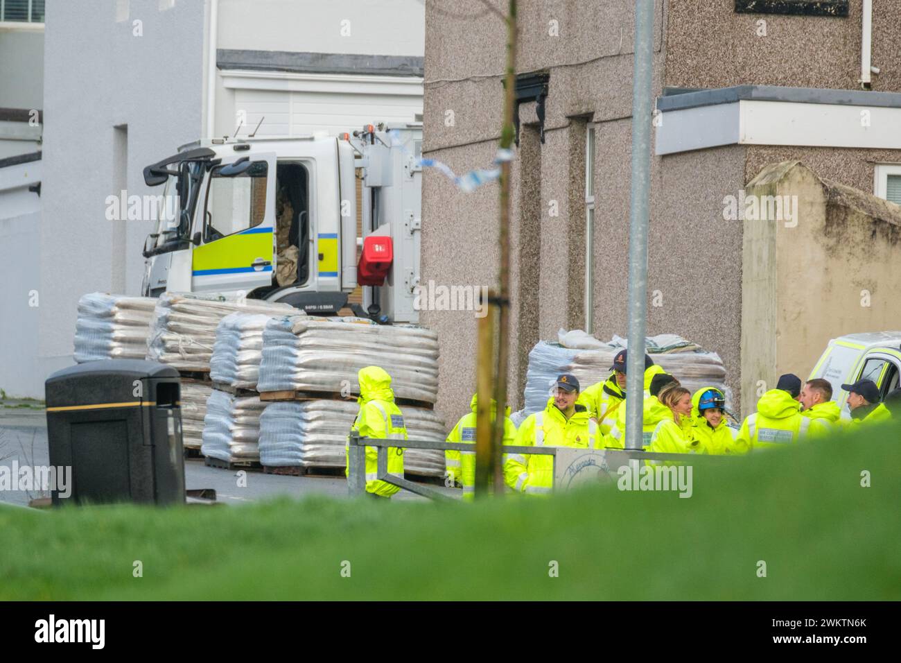 Members of HM Coastguard Search and Rescue gather after homes were ...