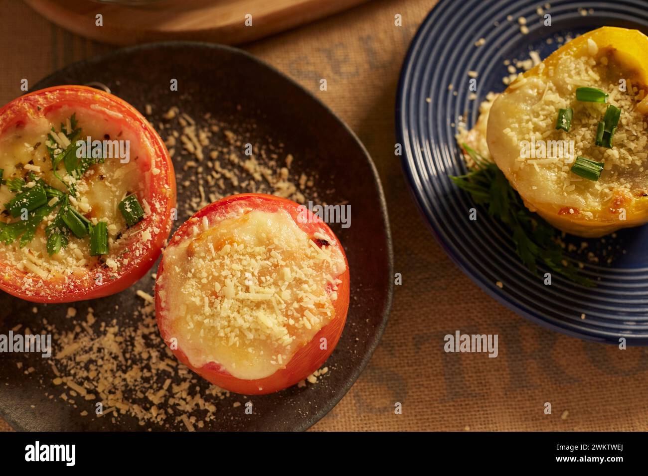 Two plates with stuffed tomatoes and grated rice Stock Photo