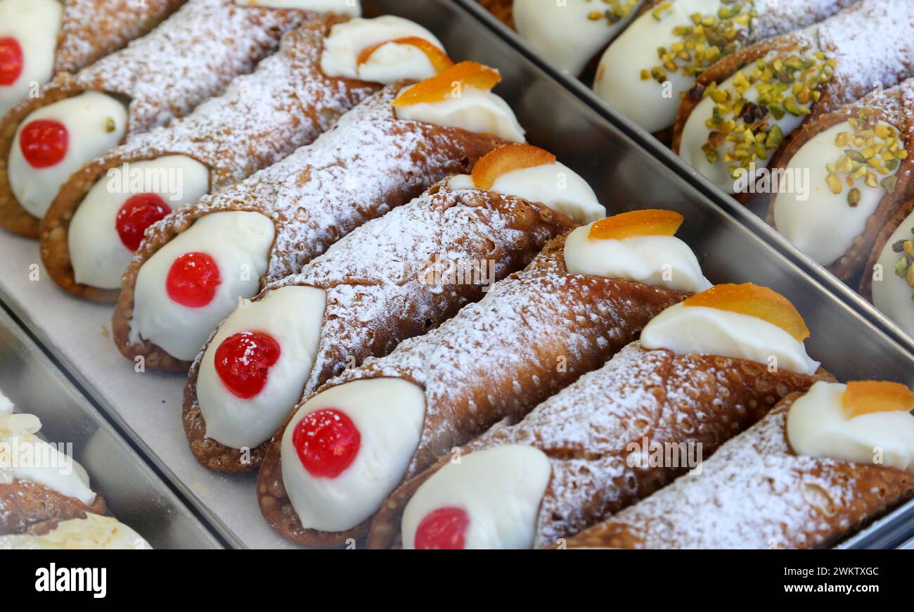 typical Sicilian dessert from southern Italy called CANNOLO SICILIANO filled with ricotta cheese candied cherry Stock Photo