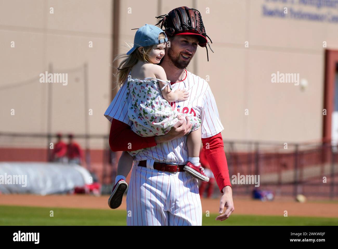 Philadelphia Phillies pitcher Matt Strahm walks on the field with his daughter Wren during a