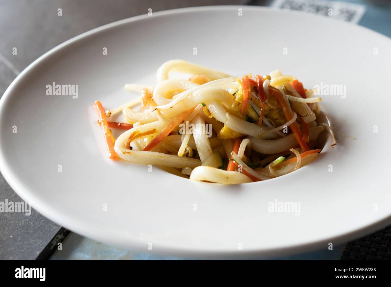 Stir-fried Yaki Udon noodles with shrimps seafood, vegetables and soy-based Sauce. Japanese food. Stock Photo