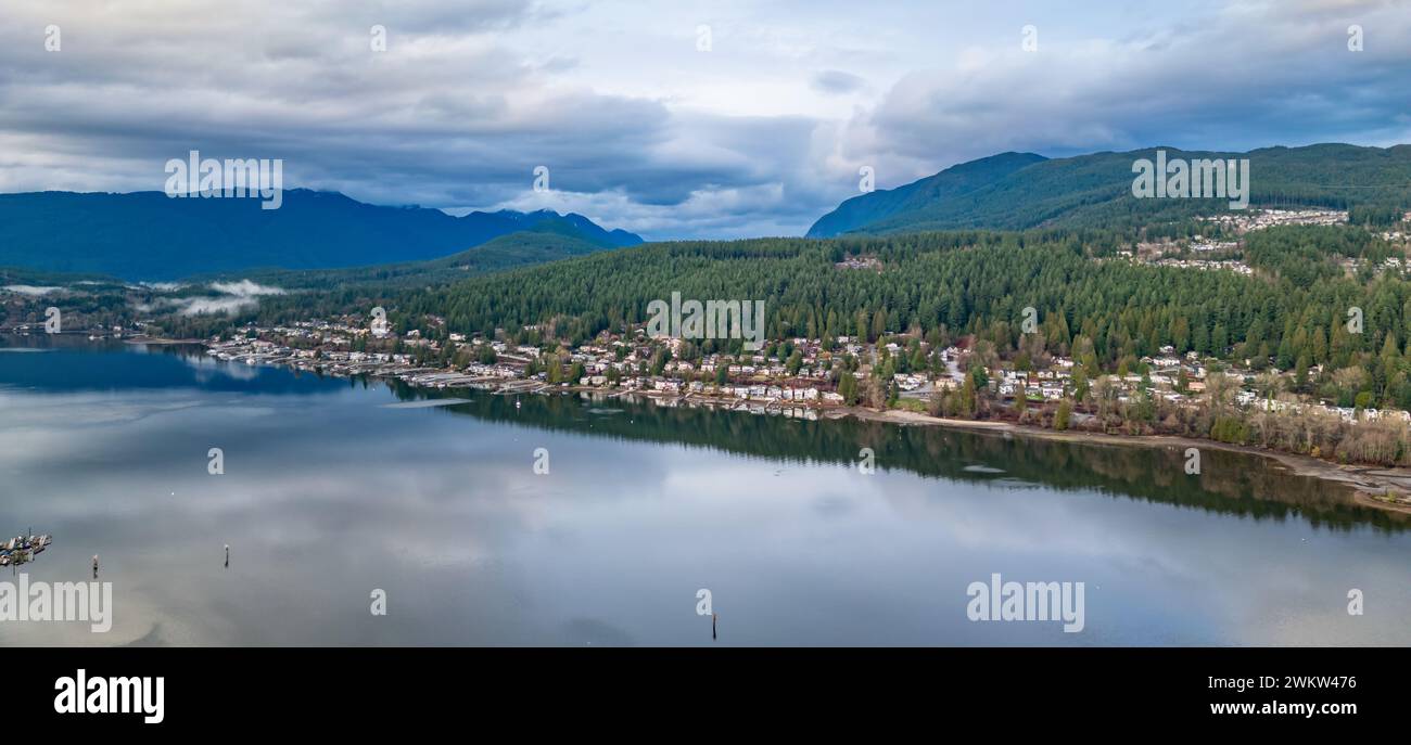 Residential Homes on the Ocean Shore with mountains in background. Port Moody, Vancouver, BC, Canada. Stock Photo