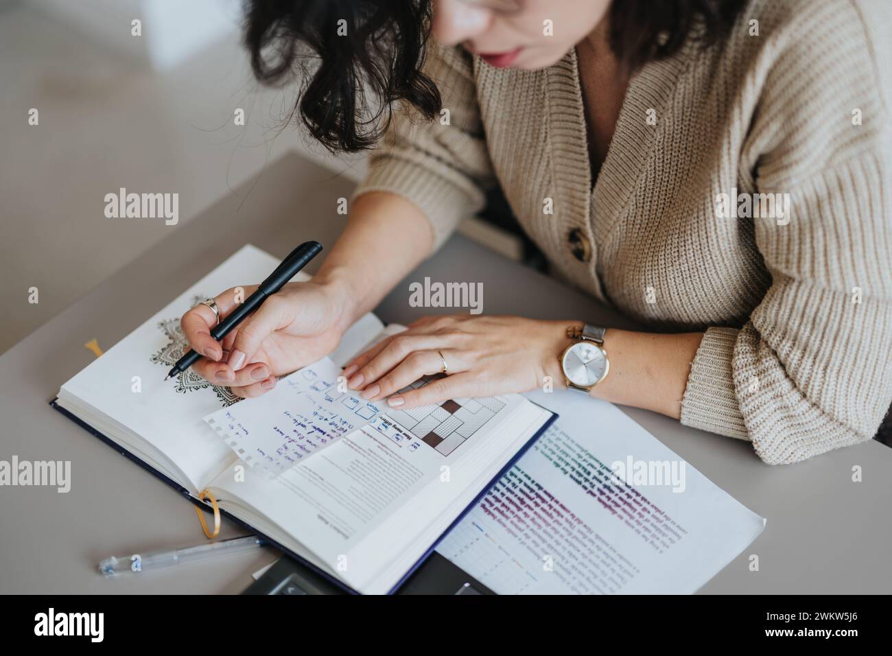 Woman writing stats or project notes down in a notebook. Stock Photo