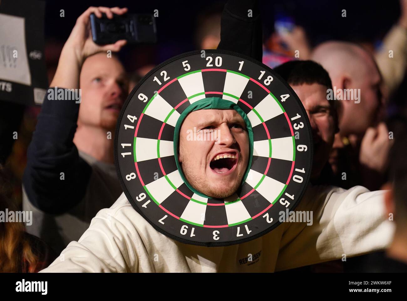A fan wearing a dartboard costume in the crowd during night four of the 2024 BetMGM Premier League at the Utilita Arena Newcastle. Picture date: Thursday February 22, 2024. Stock Photo