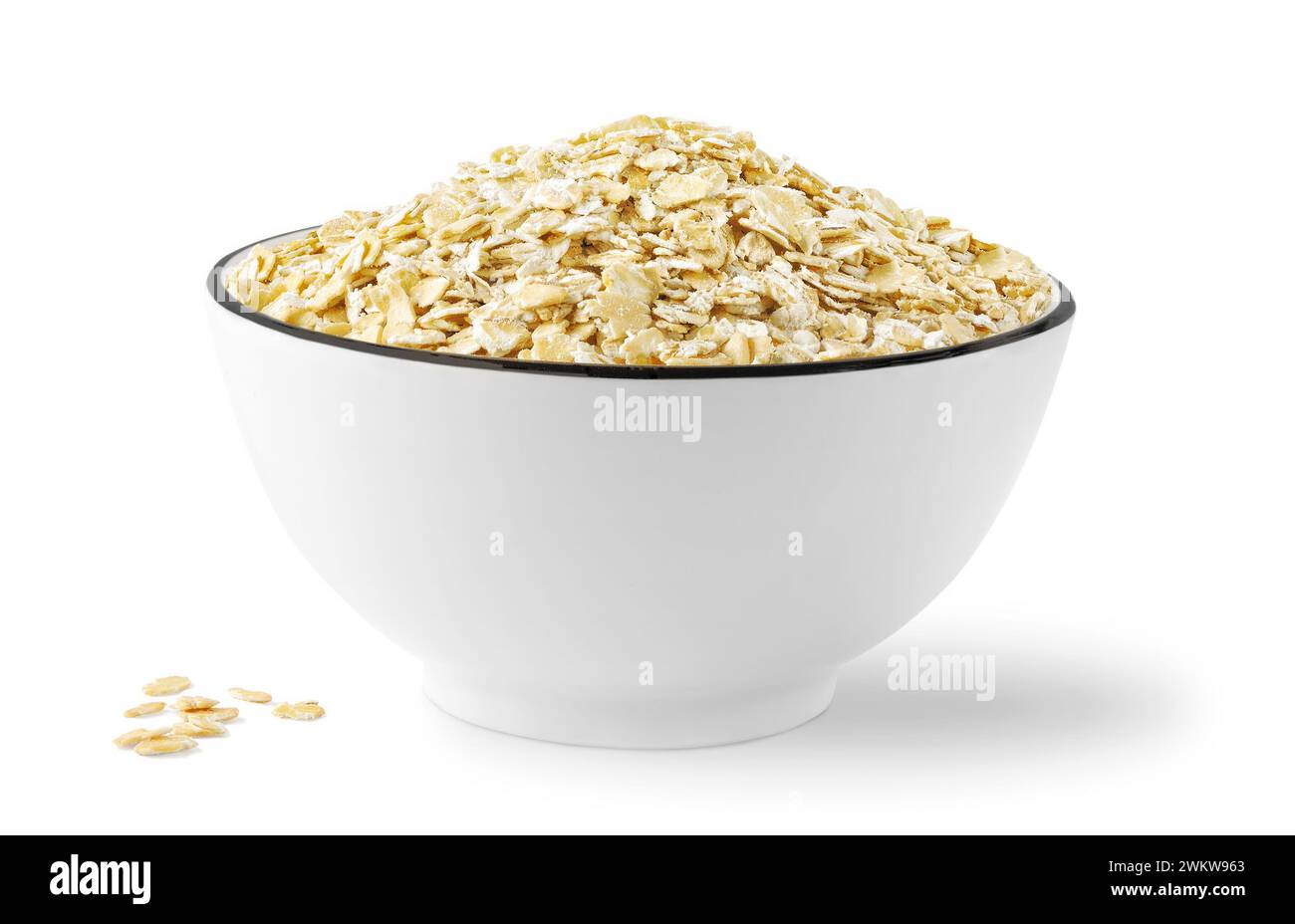 Bowl of dry rolled oats, isolated on white background Stock Photo