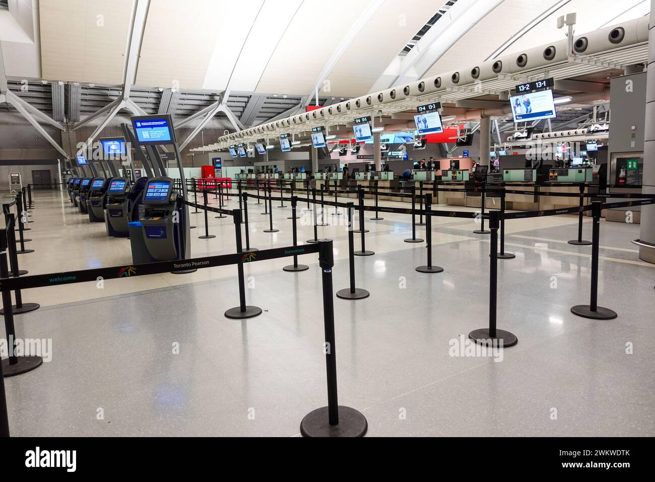 No one waiting at airline check-in counters inside the airport. Stock Photo