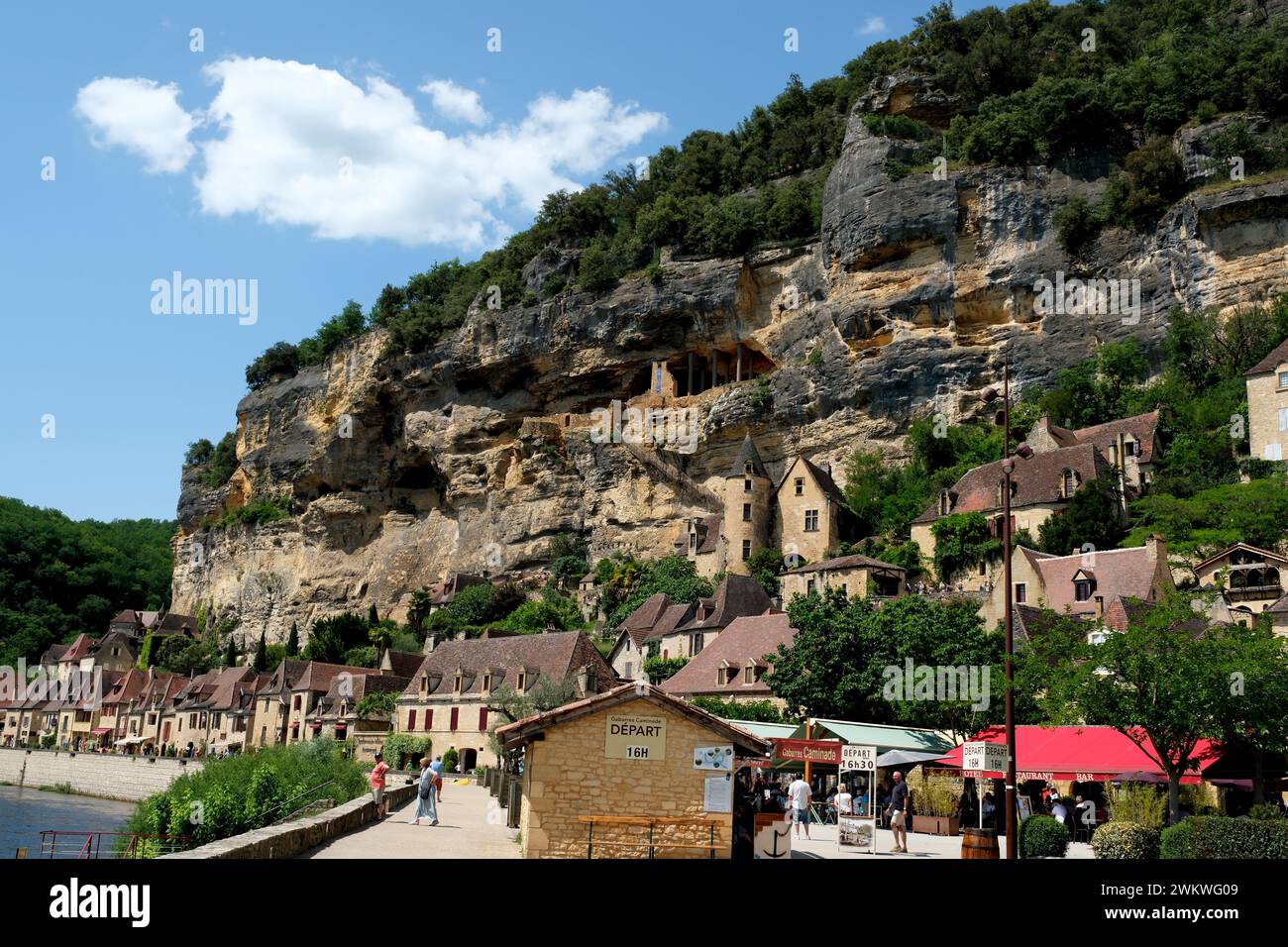 The picturesque French village of La Roque-Gageac on the banks of the Dordogne River is a favorite destination for tourists and water sport lovers Stock Photo