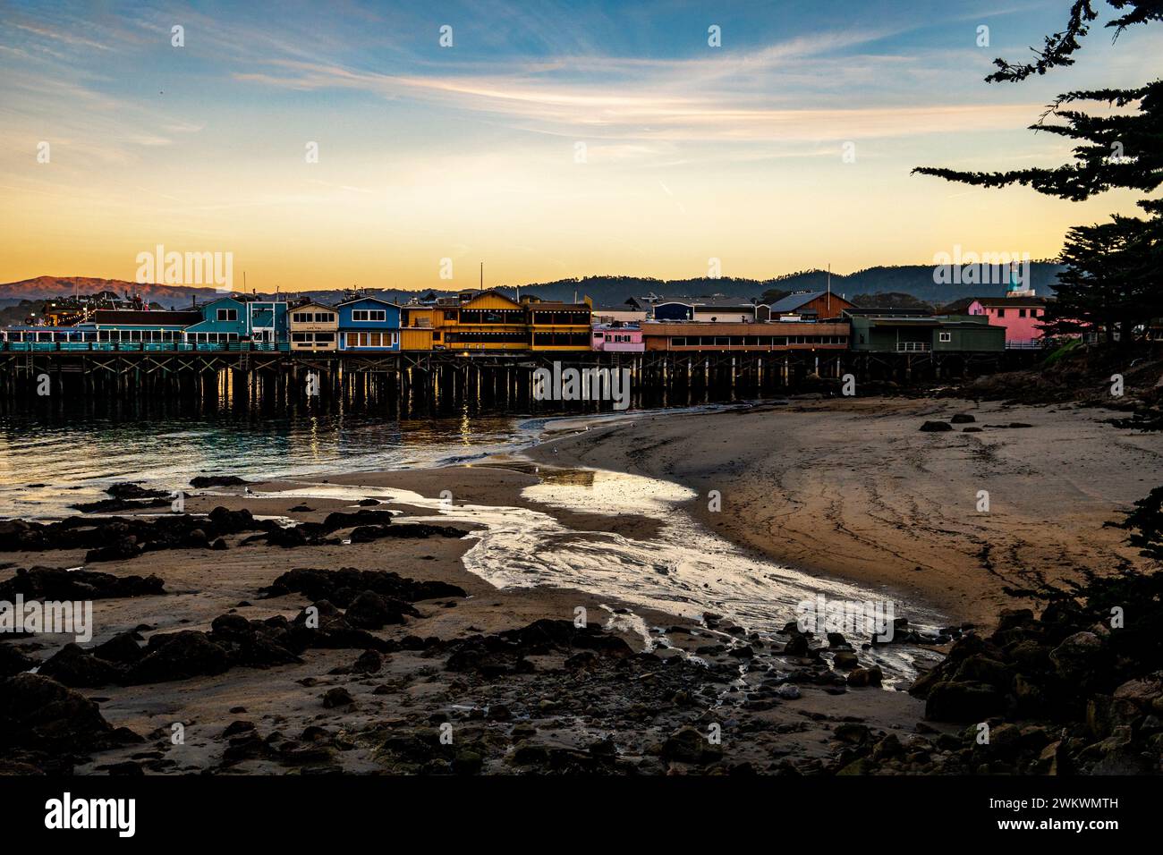 Sunset and low tide at Montetey, CA's Old Fisherman's Wharf Stock Photo