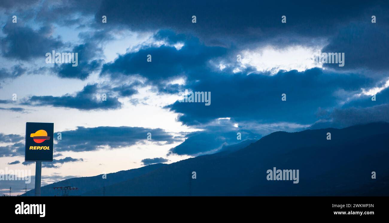 Caceres, Spain - Oct 14th 2023. Repsol highway Petrol Station sign pole. Passage of mountains with cloudy dawn sky Stock Photo