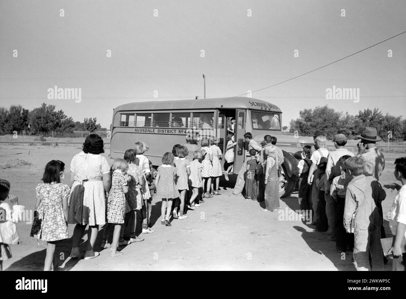 Children of migratory laborers who are living at migratory labor camp boarding school bus, Agua Fria, Arizona, USA, Russell Lee, U.S. Farm Security Administration, March 1940 Stock Photo