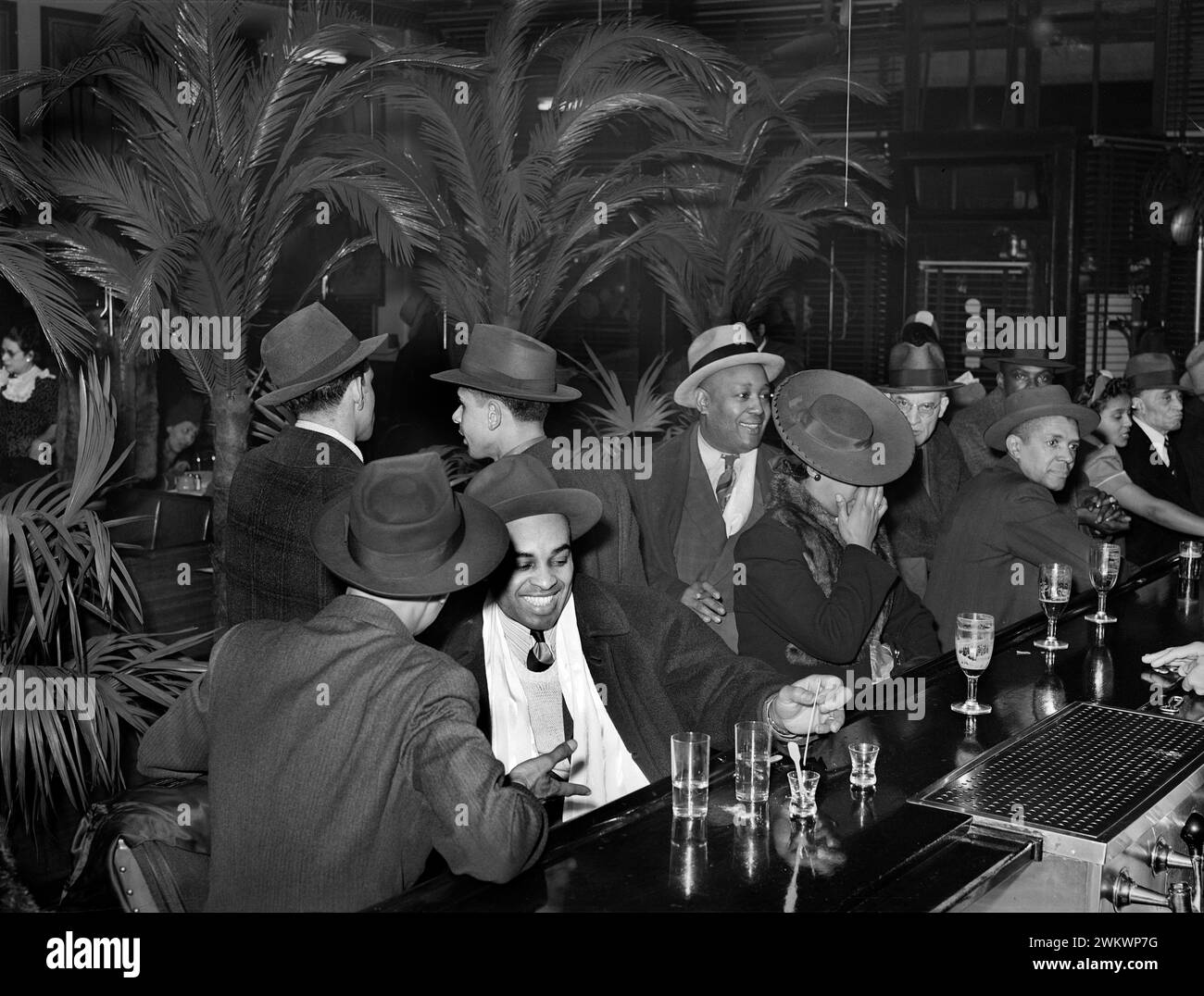 Group of adults at the bar at Palm Tavern, Chicago, Illinois, USA, Russell Lee, U.S. Farm Security Administration, April 1941 Stock Photo