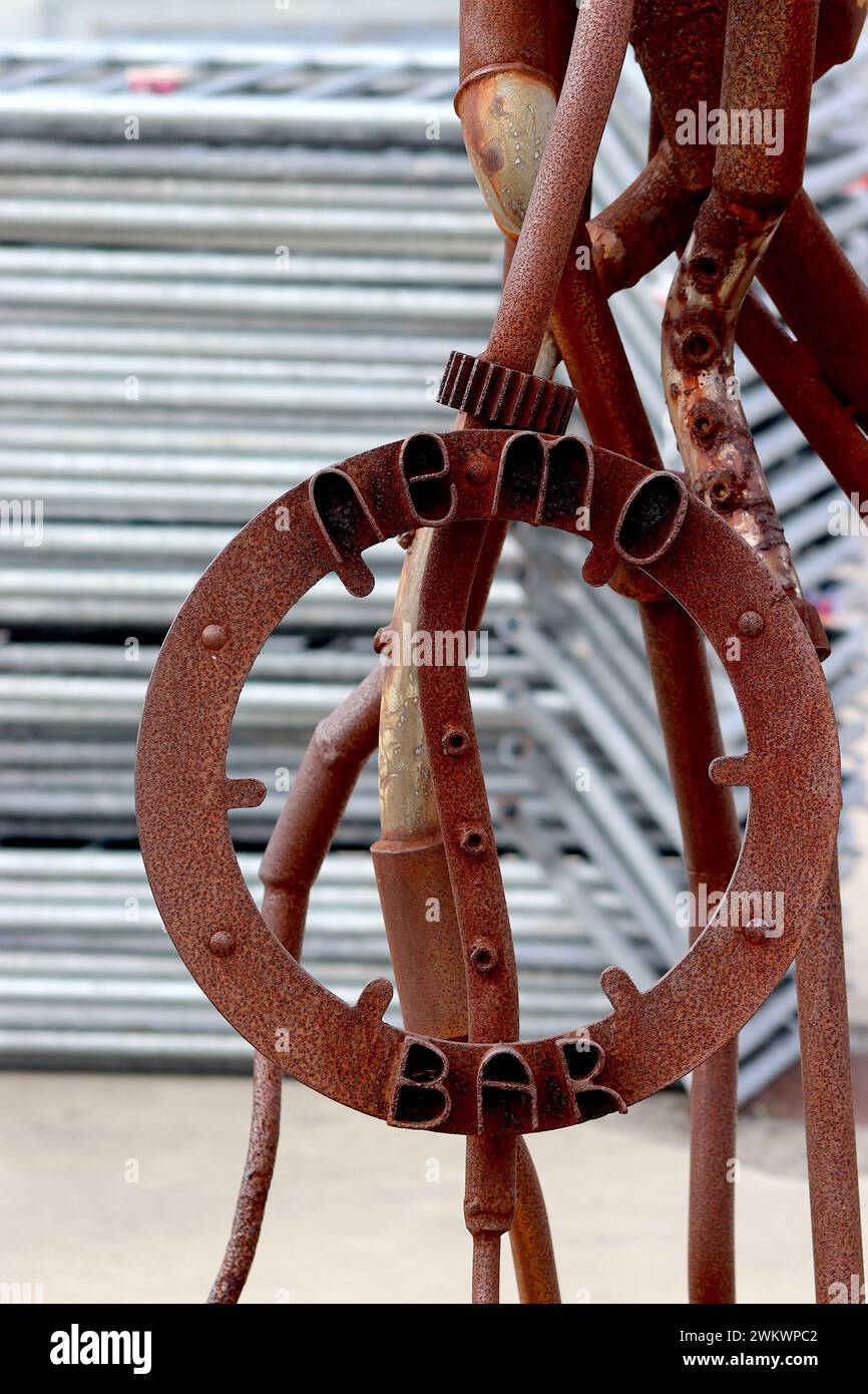 Close up of the nameplate of Nemo’s Bar, consisting of a rustic sculpture using numerous scrap metal items including pipes, gears and ball races. Stock Photo