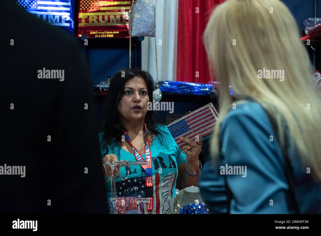 National Harbor, Maryland, USA. 22nd Feb 2024. A woman selling bedazzled items, including purses, hats, and pins, at the 2024 Conservative Political Action Conference (CPAC) in National Harbor, Maryland, U.S., on Thursday, February 22, 2024. Credit: Annabelle Gordon /CNP /MediaPunch Credit: MediaPunch Inc/Alamy Live News Stock Photo