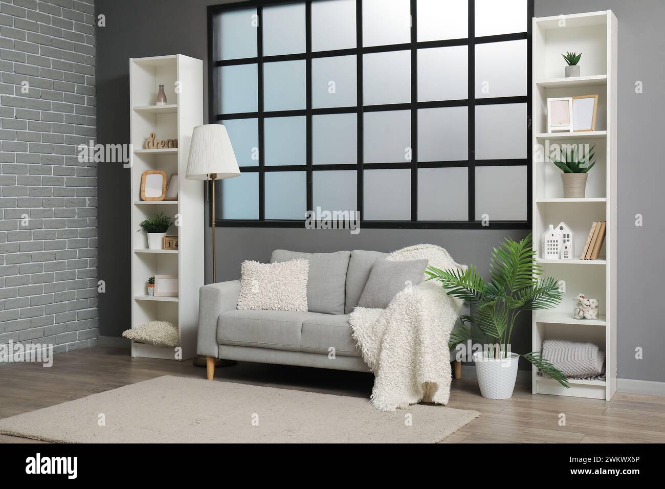 Stylish interior of modern living room with grey sofa Stock Photo - Alamy
