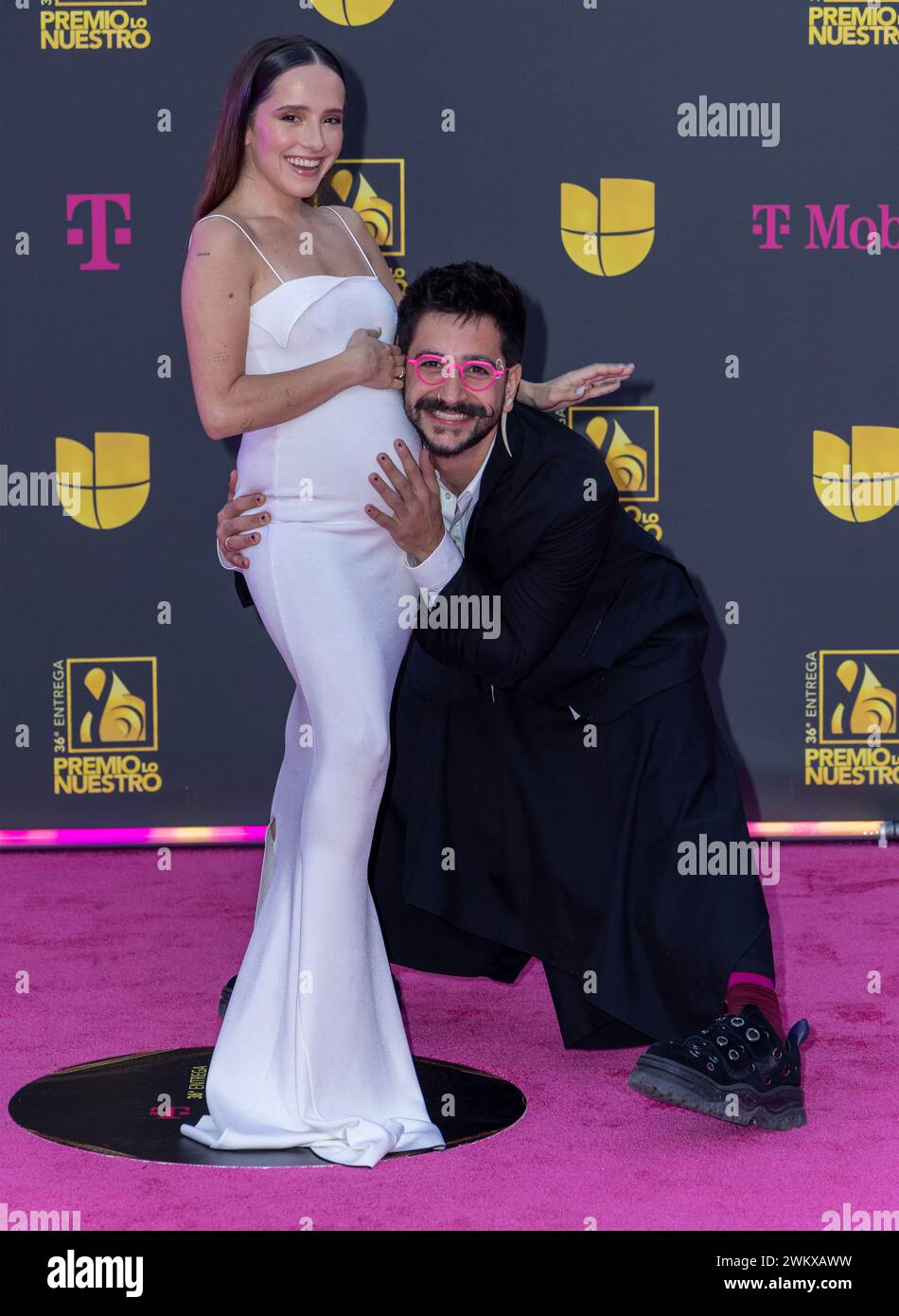 Camilo (R) and Evaluna Montaner walk the red carpet at the Univision