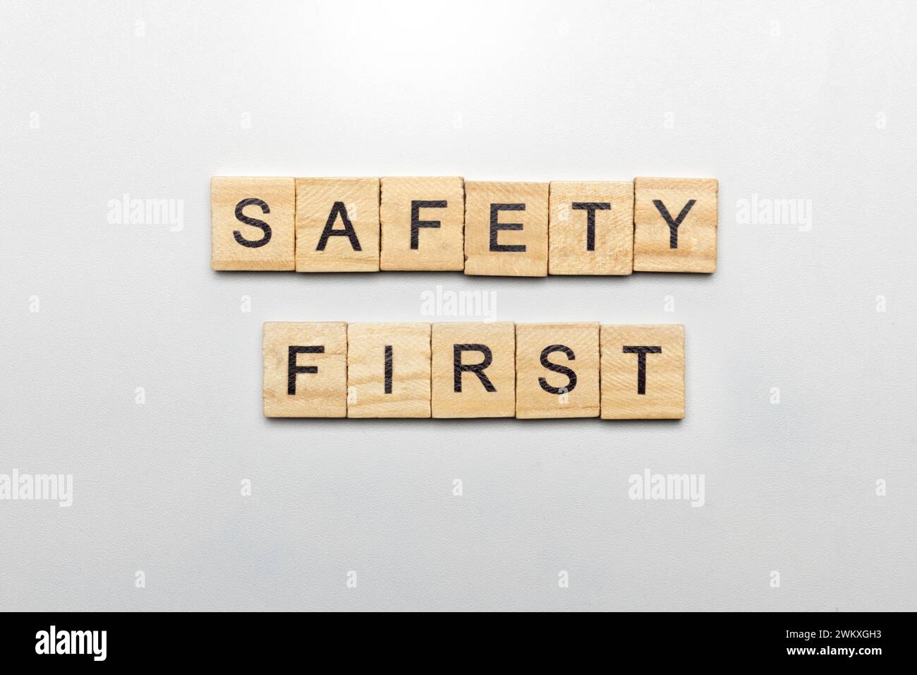 The row of wooden cubes with 'safety first' text on a white background ...