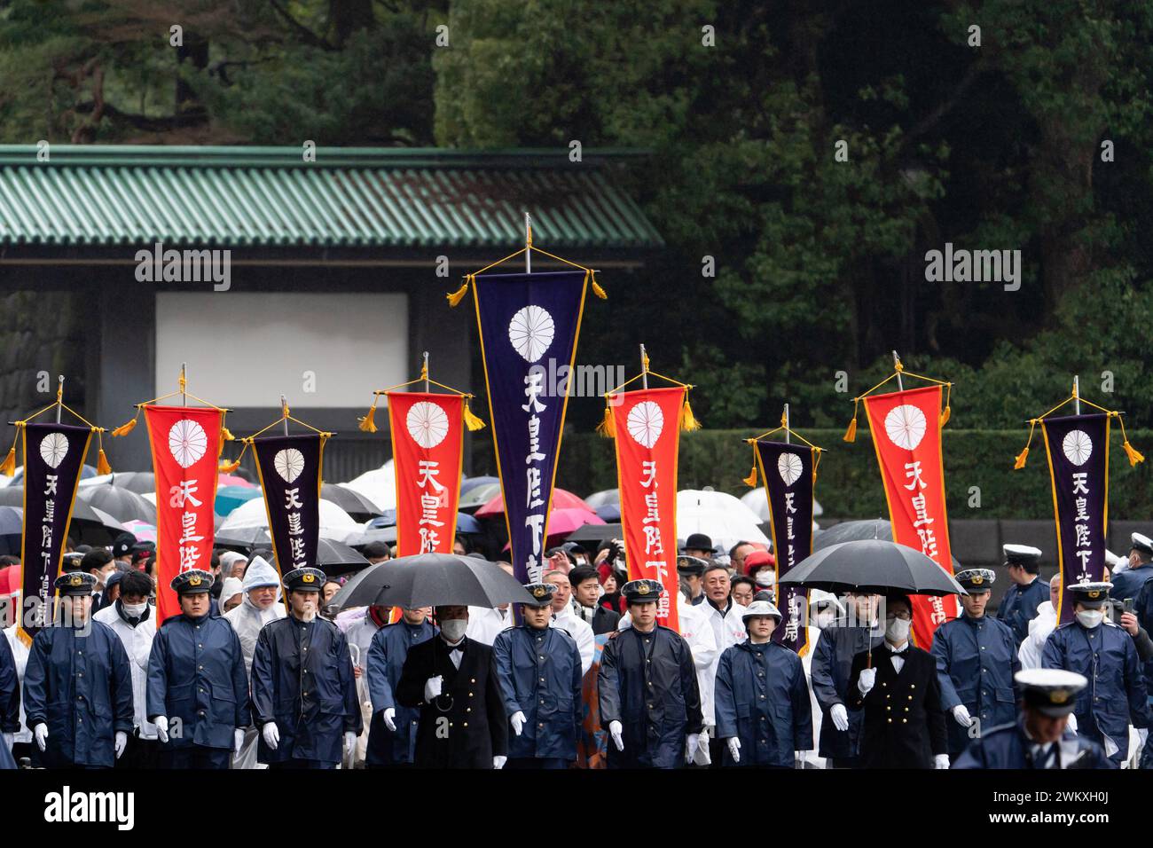 Tokyo, Japan. 23rd Feb, 2024. Police officers escort well-wishers arriving for the appearance of Japan's Emperor Naruhito (not pictured) at the Imperial Palace on February 23, 2024, in Tokyo, Japan. Emperor Naruhito appeared to greet the public on his 64th birthday, flanked by Empress Masako and other members of the Japanese Royal Family. Credit: SOPA Images Limited/Alamy Live News Stock Photo