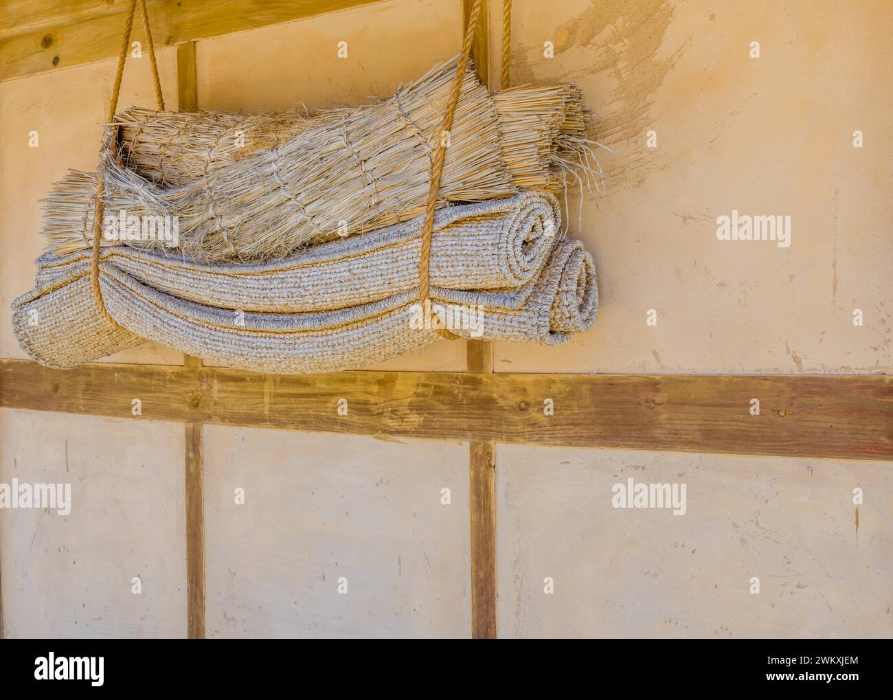 Traditional Korean sleeping mats hanging in rope on exterior wall in