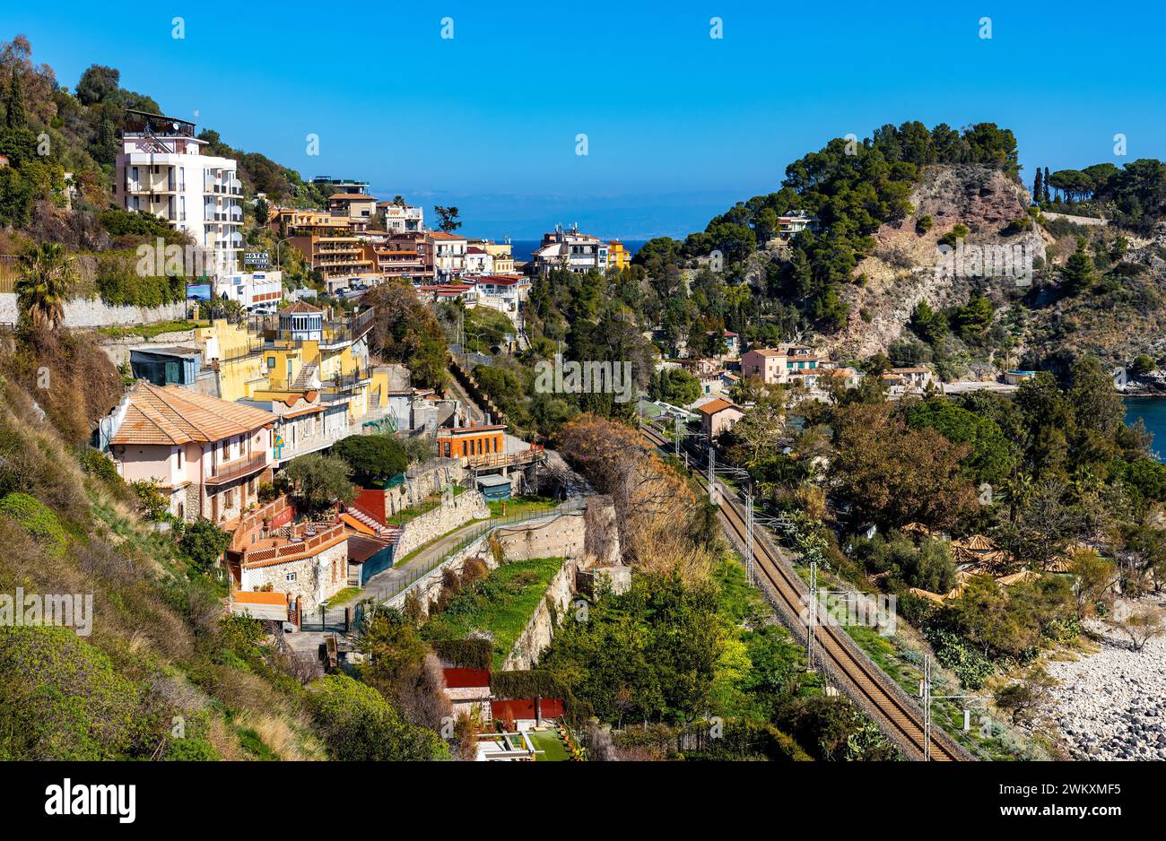 Taormina, Sicily, Italy - February 15, 2023: Panoramic view of Taormina and Mazzaro town at Ionian sea shore seen from Funivia Cable Car gondola Stock Photo