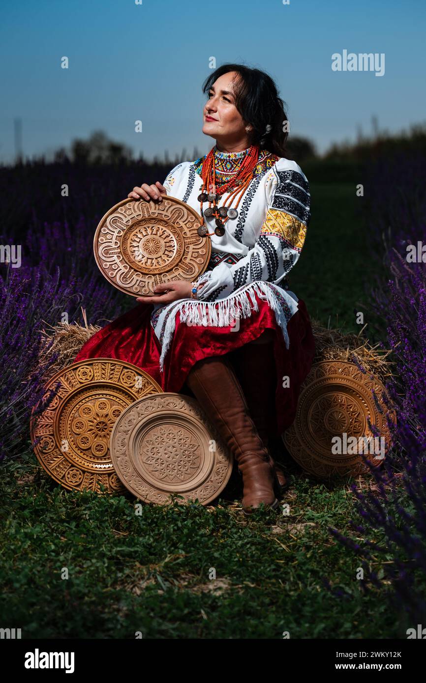 Ivano-Frankivsk, Ukraine August 14, 2023: a woman conveys all Ukrainian ethnicity and style, a woman holds a carved plate in her hands, Ukrainian cult Stock Photo