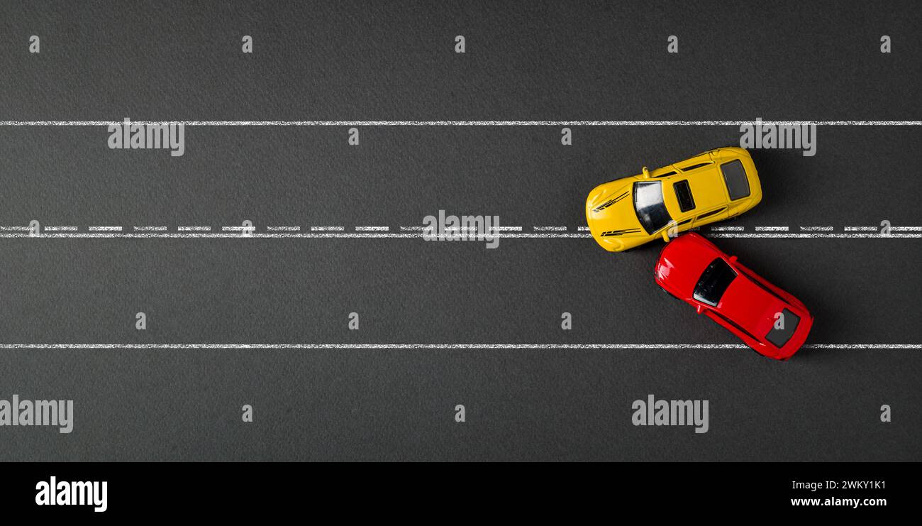 Top view of red and yellow cars colliding and crashing on dark gray background Stock Photo