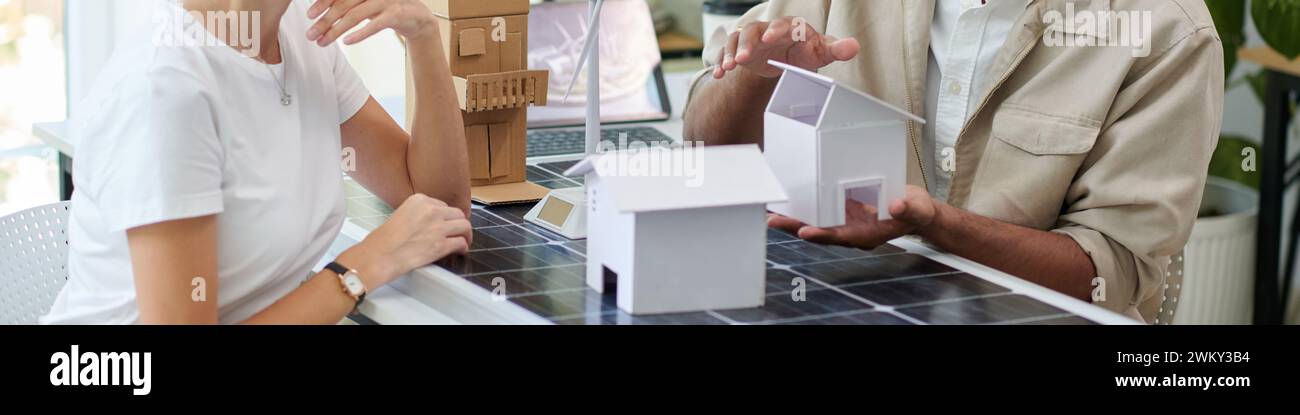 Header with manager explaining client how to install solar panels on ...
