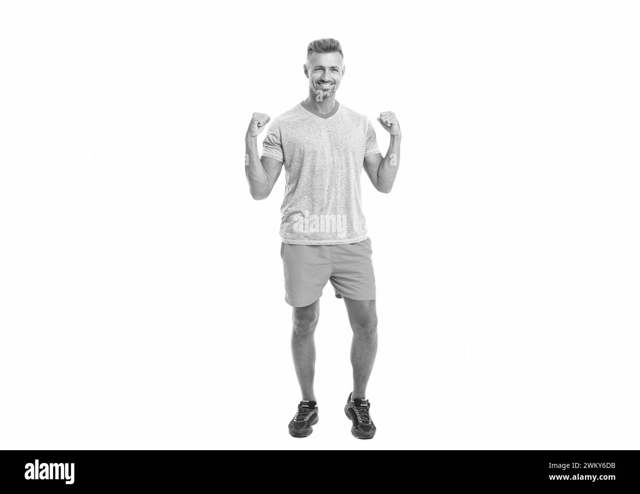 Handsome successful sport man after workout in studio. runner sport man isolated on white background. Athletic mature sport man standing. Sport man Stock Photo
